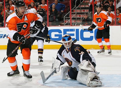 Jeff Carter can't get the puck past Thrashers goalie Chris Mason, who makes 43 saves to shut out the Flyers. (Getty Images)