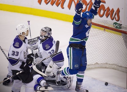 Raffi Torres celebrates as teammate Christian Ehrhoff's shot goes in the net past Kings goalie Jonathan Quick. (AP)