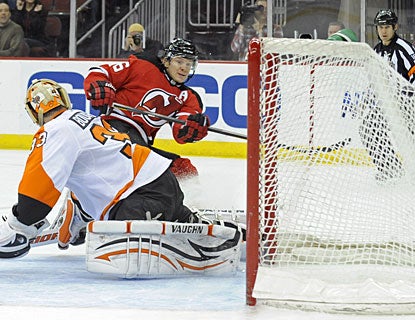 Patrik Elias scores a short-handed goal, his second of the game, before completing his eighth career hat trick. (AP)
