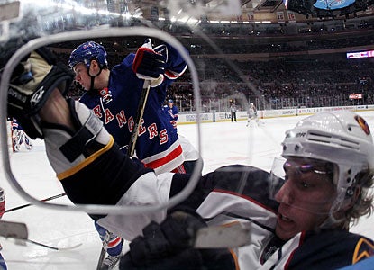 Atlanta's Alexander Burmistrov is checked hard into the glass boards by Derek Stepan. (Getty Images)