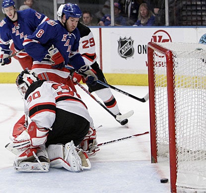 Just off the bench, Brandon Prust (8) charges to the net and is able to put a backhand rebound under Martin Brodeur. (AP)