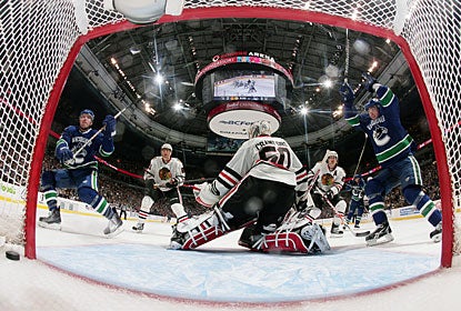 Alex Burrows and Christian Ehrhoff celebrate what turns out to be the game-winning goal by Daniel Sedin. (Getty Images)