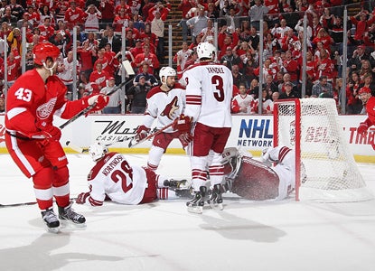 Coyotes players look on as goalie Ilya Bryzgalov lets a shot from Darren Helm (43) get by for a goal in the first period. (Getty Images)