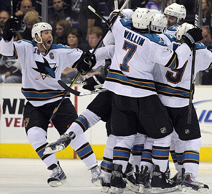 Teammates are all over Devin Setoguchi, who nets the winner and caps an incredible comeback win for the visiting Sharks. (AP)