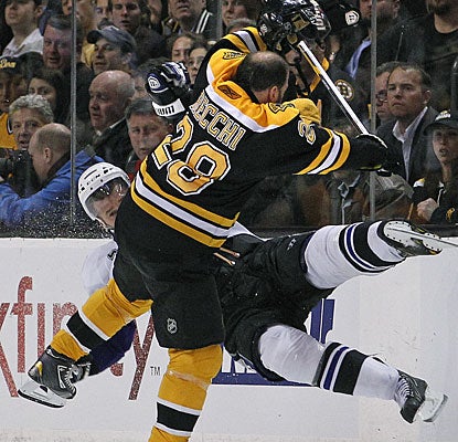 Mark Recchi gets a busted lip and lots of cheers from the Boston faithful after this huge collision with Mattias Ohlund. (AP)