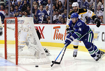 Alex Burrows takes advantage of an out-of-position Tim Thomas to put the puck in the net on a wraparound. (Getty Images)