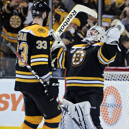 Tim Thomas (right) celebrates a Game 6 victory with Zdeno Chara after stopping 36 of 38 shots.  (Getty Images)