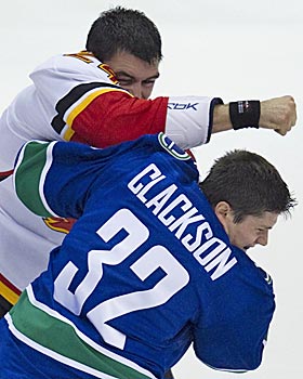 The NHL is punishing goons like the Flames' Pierre-Luc Letourneau-Leblond (left) for dirty hits by taking away games. (AP)