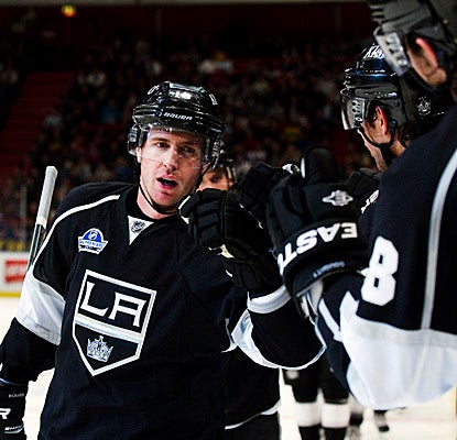 Mike Richards is greeted by high-fives after he scores in the Kings' season opener against the Rangers in Stockholm. (Getty Images)