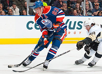 Ales Hemsky (83) carries the puck past Kris Letang (58) of the Pittsburgh Penguins for a chance on goal. (Getty Images)