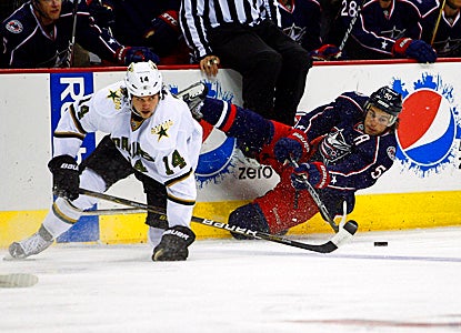 Antoine Vermette (right) of the Blue Jackets battles the Stars' Jamie Benn for the puck. (Getty Images)
