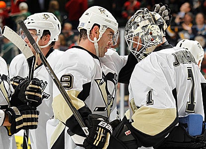 Pascal Dupuis (#9) celebrates with his depleted team after beating the Wild. (Getty Images)