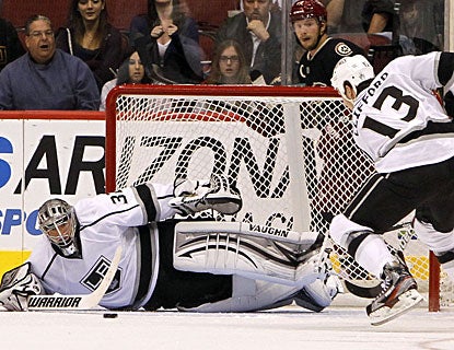 Jonathan Quick makes a save on Coyotes captain Shane Doan (behind net) to preserve the shutout. (AP)