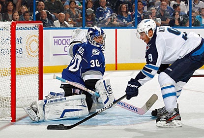 Dwayne Roloson forces Evander Kane wide to protect a perfect sheet with 28 saves for his 29th career shutout. (Getty Images)