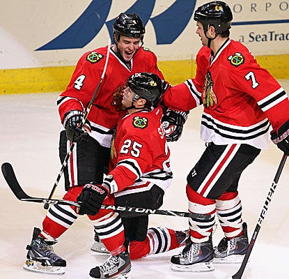 Chicago's Viktor Stalberg (center) celebrates his OT game-winning goal on Nashville goalie Pekke Rinne. (Getty Images)