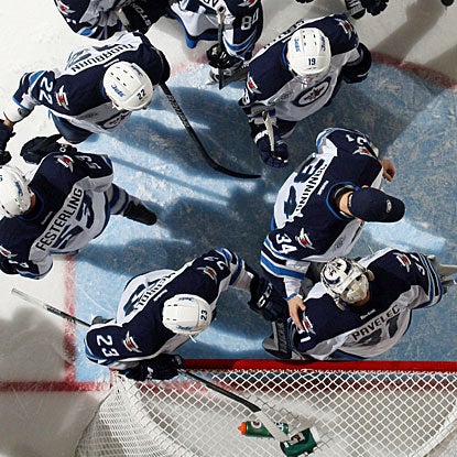 After stopping everything thrown his way, Ondrej Pavelec gets appreciation from his teammates. (Getty Images)