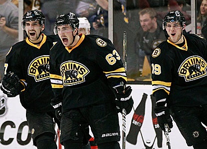 Brad Marchand (center) is getting used to celebrating.  He scores a goal for the third straight game to help the Bruins roll. (Getty Images)