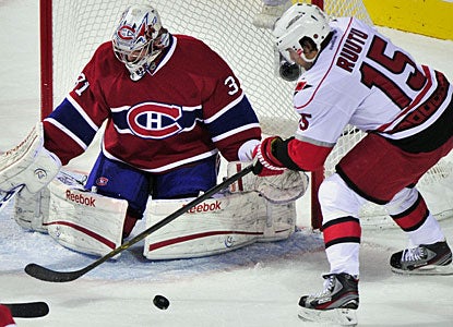 Carey Price, who also notches a secondary assist on a Montreal goal, denies Tuomo Ruutu for one of his saves. (AP)