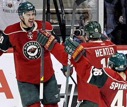 Devin Setoguchi celebrates with teammates after scoring the only goal with 2:31 to play in the game. (AP)