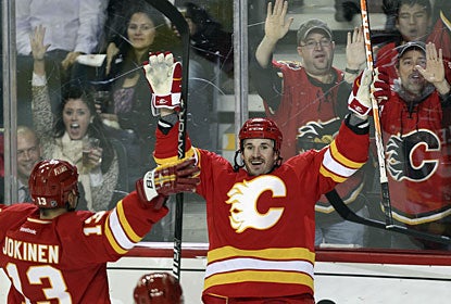 Curtis Glencross celebrates one of his goals with Olli Jokinen and fans behind the glass, too. (Getty Images)
