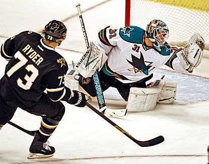 The Sharks' Antti Niemi (right) stops 30 shots in Dallas' defeat against San Jose. (AP)