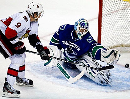 In the absence of an injured Roberto Luongo, Cory Schneider stops 28 shots from the Ottawa Senators to aid in Vancouver's win. (AP)