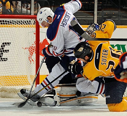 Shawn Horcoff battles for the puck through the crease. Horcoff starts and finishes the scoring for Edmonton. (Getty Images)