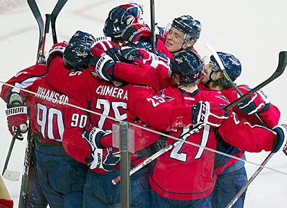 Jason Chimera gets mobbed by teammates after scoring the game-winner in OT.  It is his eighth goal in just 20 games. (Getty Images)