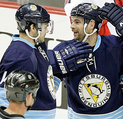Penguins' Chris Kunitz congratulates Steve Sullivan, who scores in the first period against the Ottawa Senators. (AP)