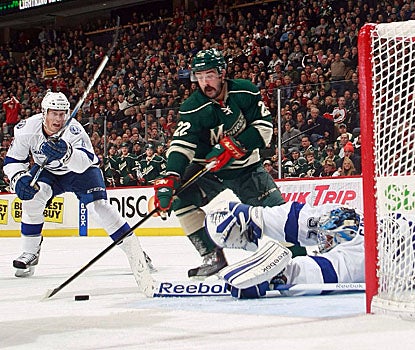 Cal Clutterbuck (center) scores a short-handed goal in the second period to help Minnesota top Tampa Bay. (Getty Images)