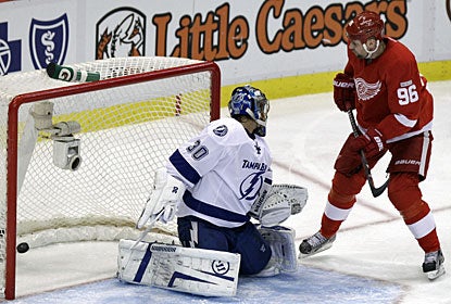 Tomas Holmstrom deflects the puck past Dwayne Roloson for his fourth goal this season. (AP)
