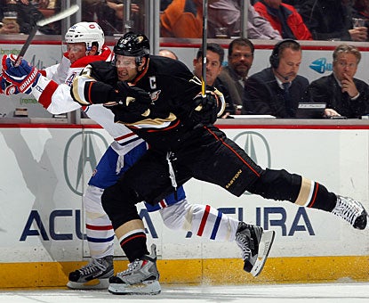 Ryan Getzlaf, who snaps a 14-game goal drought, administers a check on Montreal's Andrei Kostitsyn. (Getty Images)