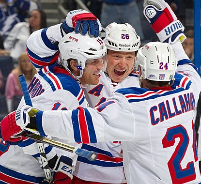 Ruslan Fedotenko (center) celebrates his goal with Brad Richards, who also gets an empty netter, and Ryan Callahan. (Getty Images)