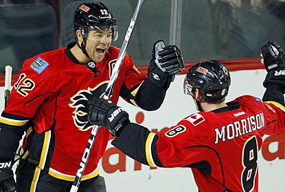 Jarome Iginla celebrates one of his two goals with Brendan Morrison, who also scores a pair of markers for Calgary. (AP)
