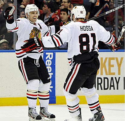 Chicago's Patrick Sharp scores two goals, including the game-winner in overtime against the Islanders. (AP)