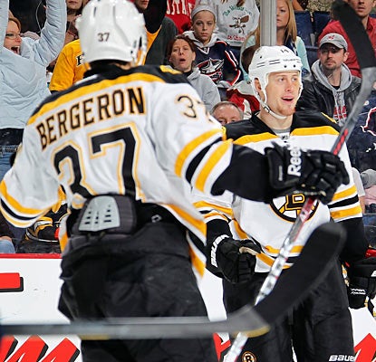 Joe Corvo (right) helps the Bruins rally from two down by providing a pair of goals against the Jackets. (Getty Images)