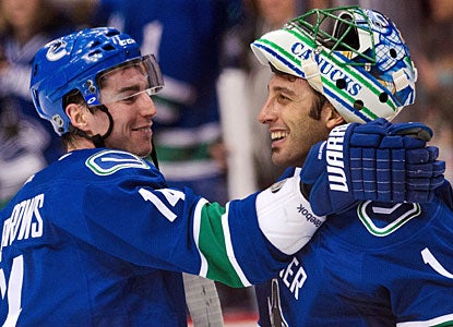 Alex Burrows, who scores for the fourth straight game, and Roberto Luongo play big against Detroit.  (Getty Images)
