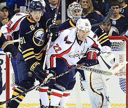 Buffalo's Brayden McNabb (81) and Washington's Mike Knuble (22) fight for position in front of goalie Ryan Miller. (US Presswire)