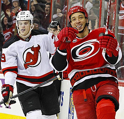 The Hurricanes' Anthony Stewart (right) celebrates his second-period goal in front of the Devils' Mark Fayne. (US Presswire)