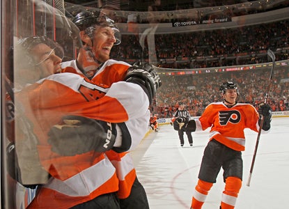 Danny Briere (48) celebrates with teammates after his game-winning goal in OT completes his hat trick. (Getty Images)