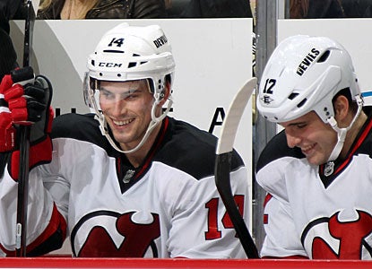 Adam Henrique (14) is all smiles on the bench after scoring New Jersey's league-best ninth short-handed goal. (Getty Images)