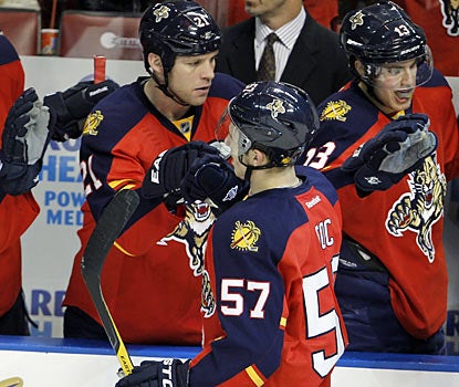 Marcel Goc (57) gets love from the Panthers bench after scoring the tiebreaking goal against the Canucks. (AP)