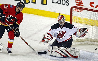 Curtis Glencross scores Calgary's third goal and assists on three other goals in each period. (AP)