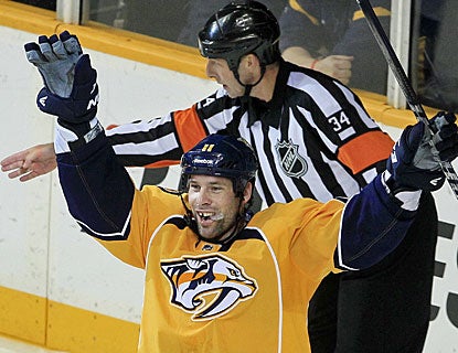 While the referee points to the net, David Legwand already knows he got the winner early in the overtime session. (AP)