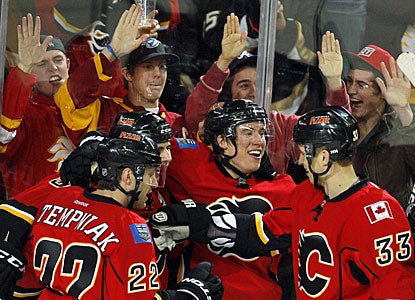 Playing in his third game in Calgary, Blair Jones (center) celebrates his timely goal with his teammates. (AP)