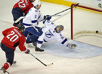 Troy Brouwer, who scores in each period, beats Dwayne Roloson here for his second goal. (AP)