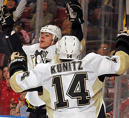Evgeni Malkin celebrates his late second-period goal with linemate Chris Kunitz. (Getty Images)