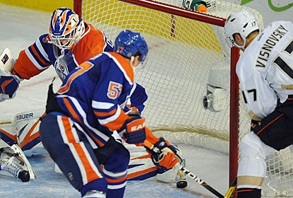 Goalie Devan Dubnyk can't prevent the puck from crossing the line for a goal by Corey Perry (not shown) in the third period. (AP)