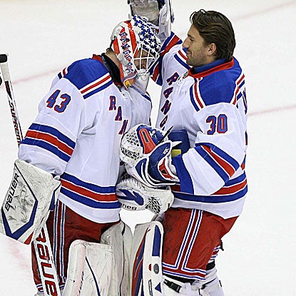 The Rangers' Henrik Lundqvist (30) congratulates his backup goalie Martin Biron on his shutout performance. (US Presswire)