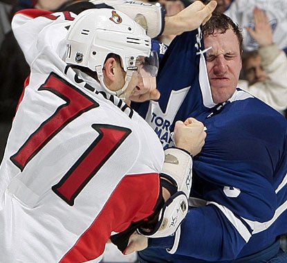 Toronto captain Dion Phaneuf (right) fights Nick Foligno after taking a low hit from the Ottawa player. (Getty Images)
